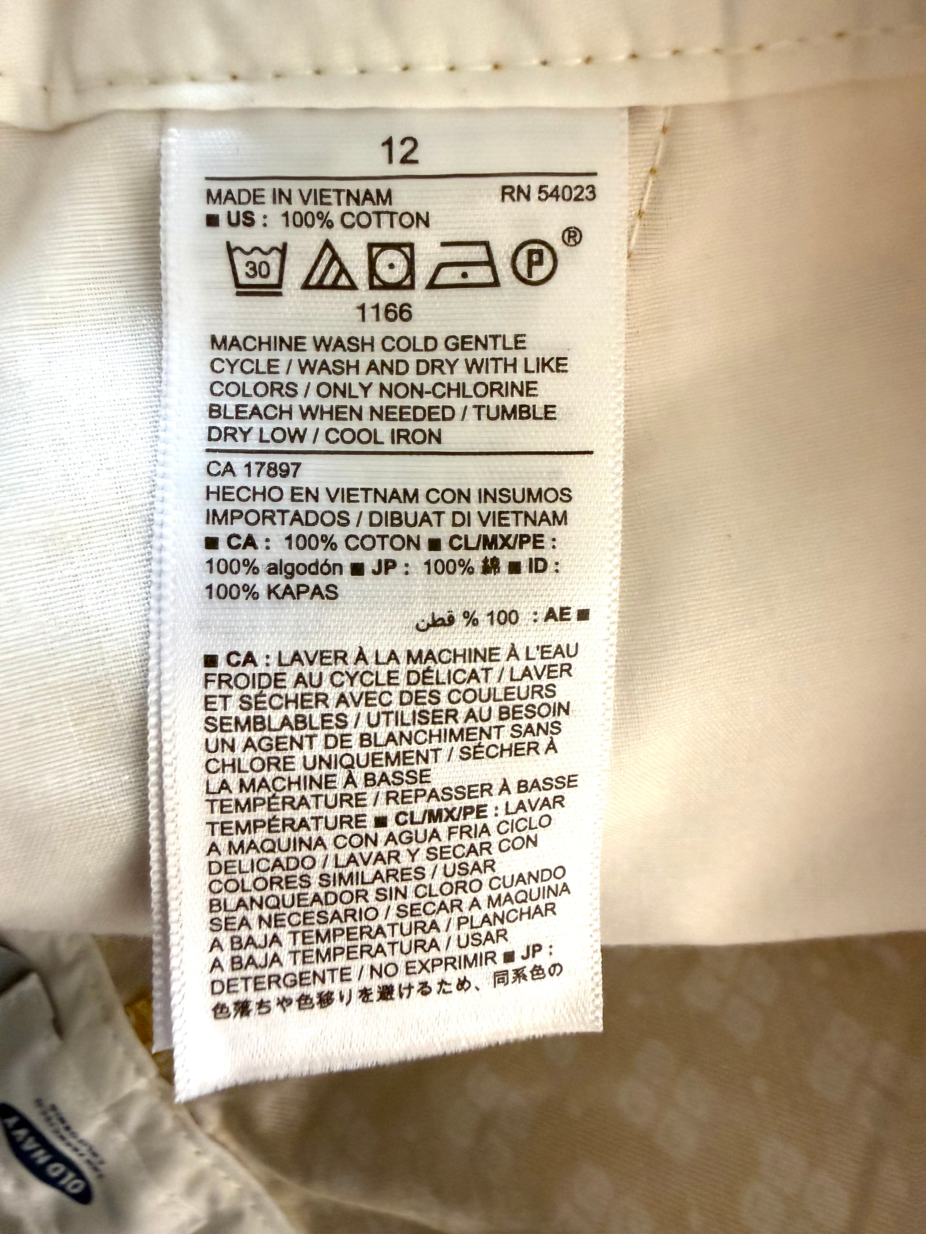 care tags inside NWT Old Navy 100% Cotton Mustard Floral Print Chino Shorts — 5" | Size 12 at Blue Sparrow Shop
