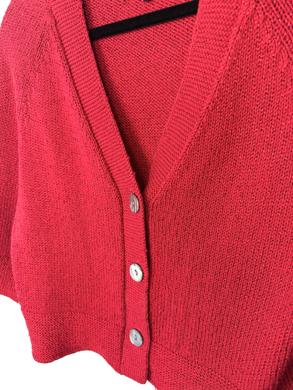 close up of buttons on front of jones new york red cardigan