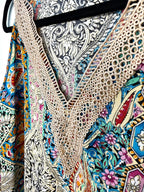close up of crochet neckline on colourful paisley bohemian blouse with crochet lace neckline