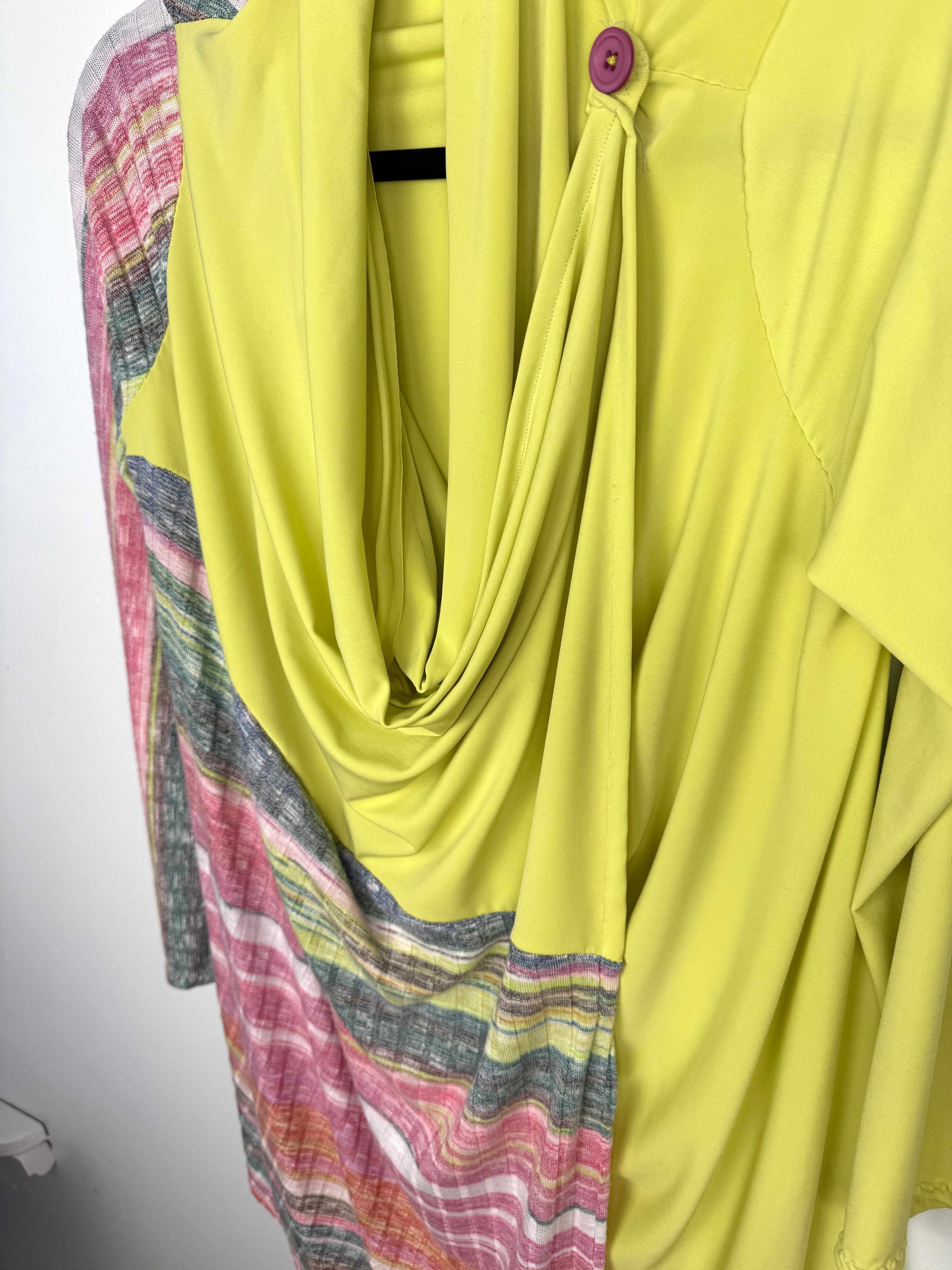 close up of draping with both buttons done up on Handmade lime green draped cardigan with asymmetrical colourblock striped panel in pink and green tones
