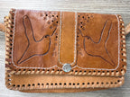 close up of front of Vintage hand tooled leather crossbody bag at Blue Sparrow Shop