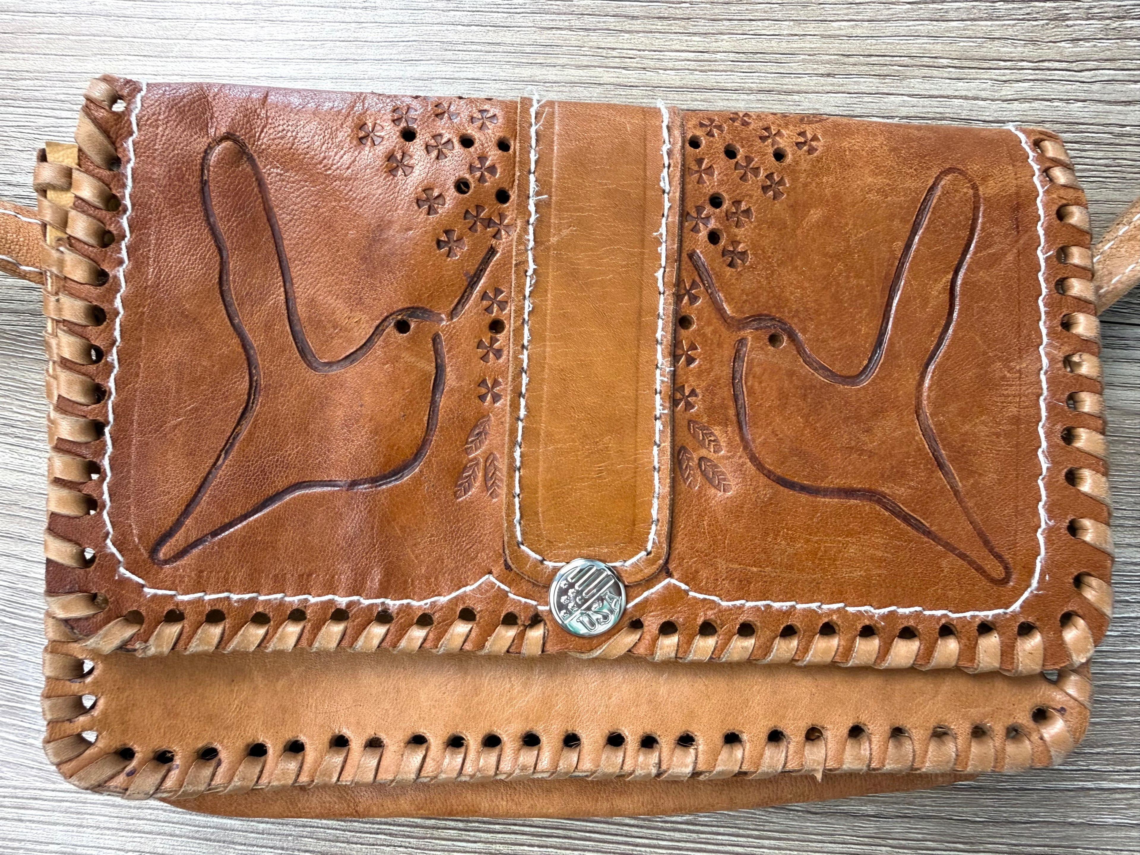 close up of front of Vintage hand tooled leather crossbody bag at Blue Sparrow Shop
