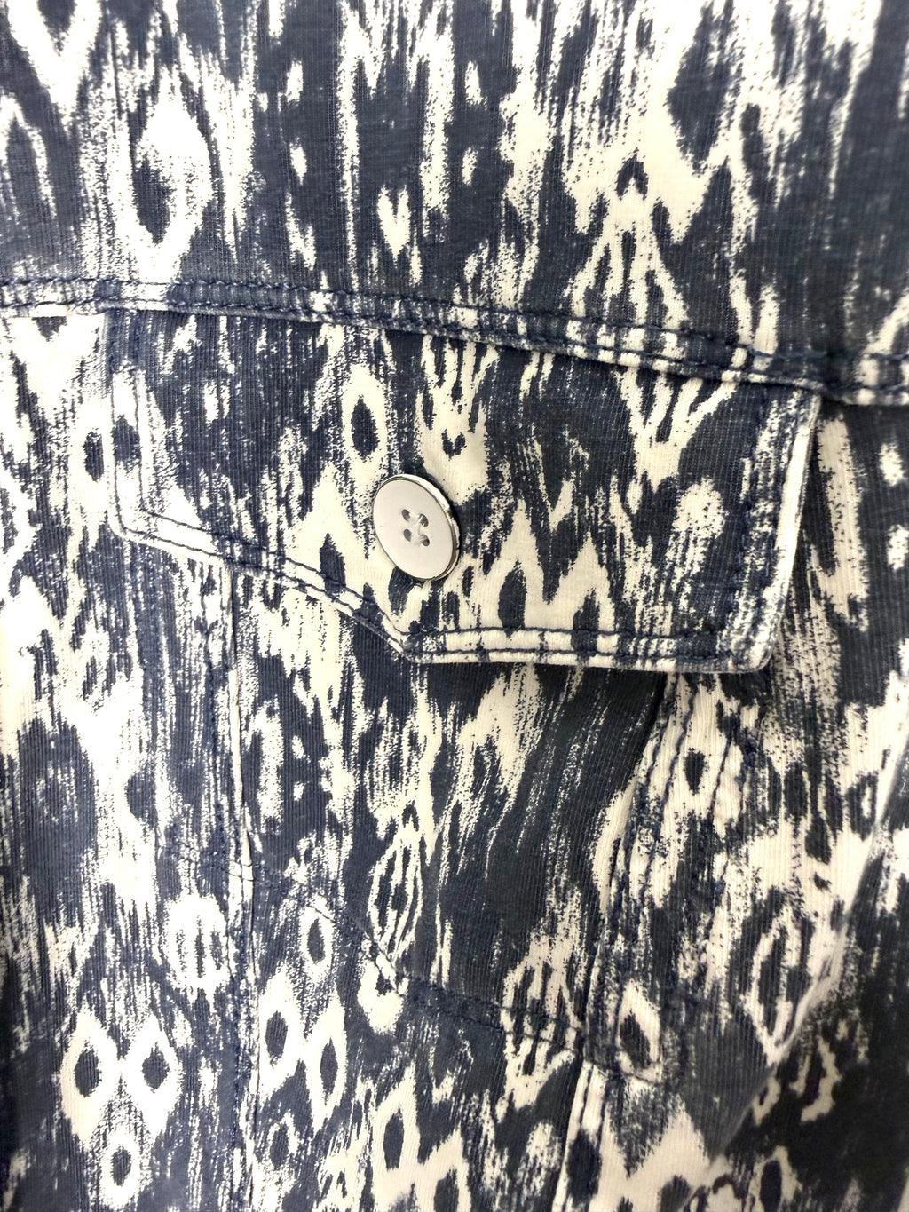 close up of front pocket on Sandwich brand jacket in denim blue and white