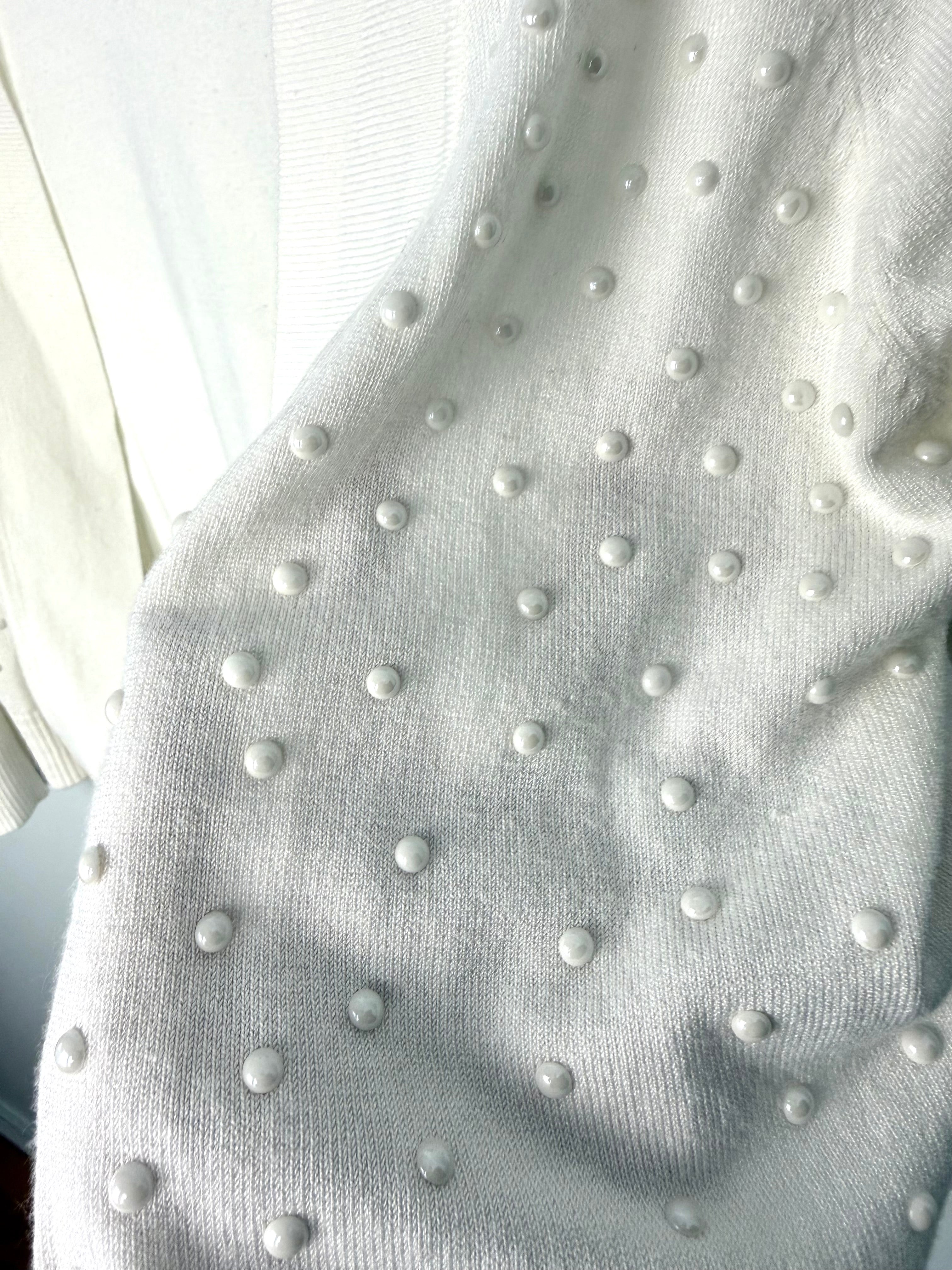 close up of pearl beading embellishment on feminine ivory cardigan sweater