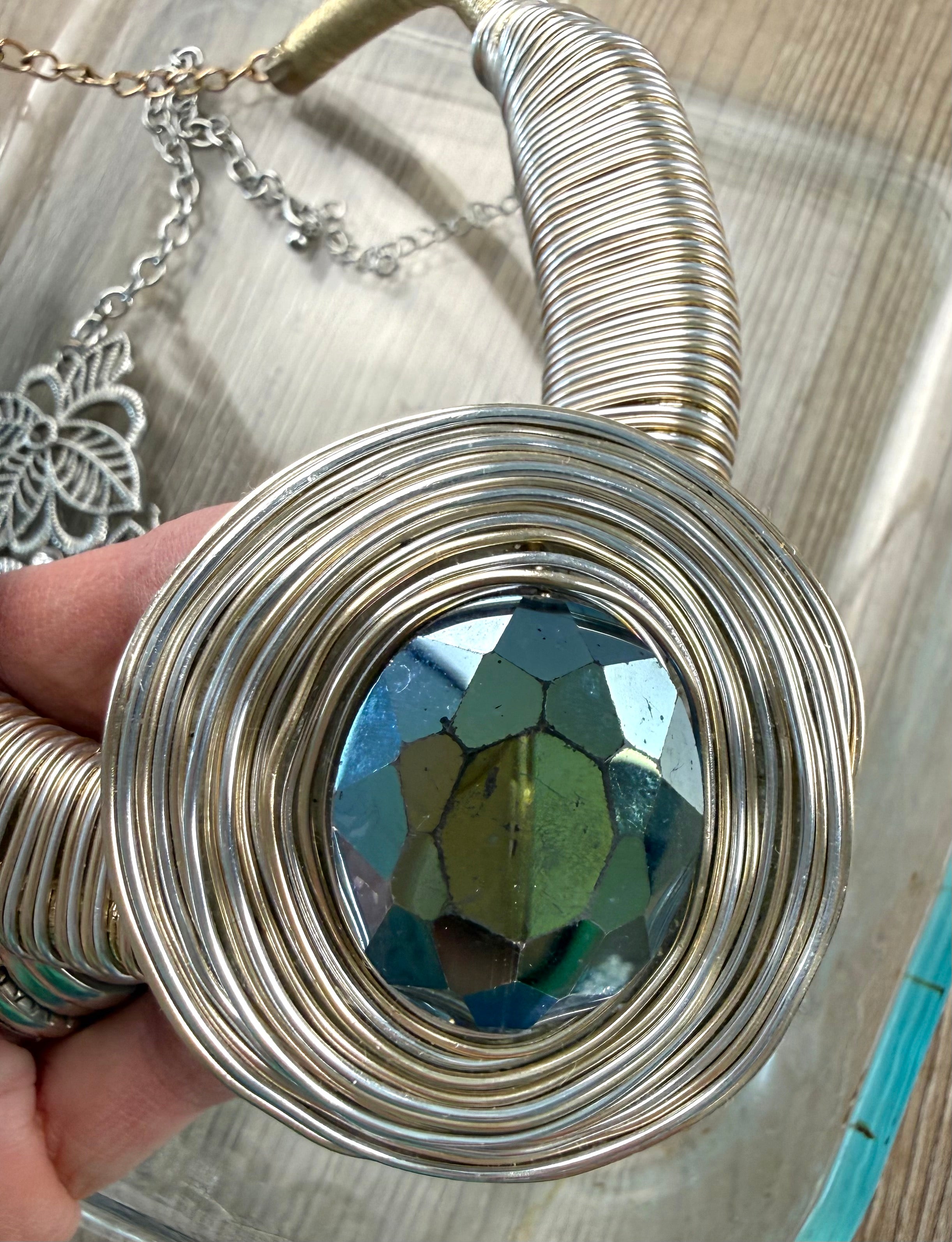 close up of pendant Gold-tone wire coil statement necklace with dark green faceted faux crystal pendant at Blue Sparrow Shop