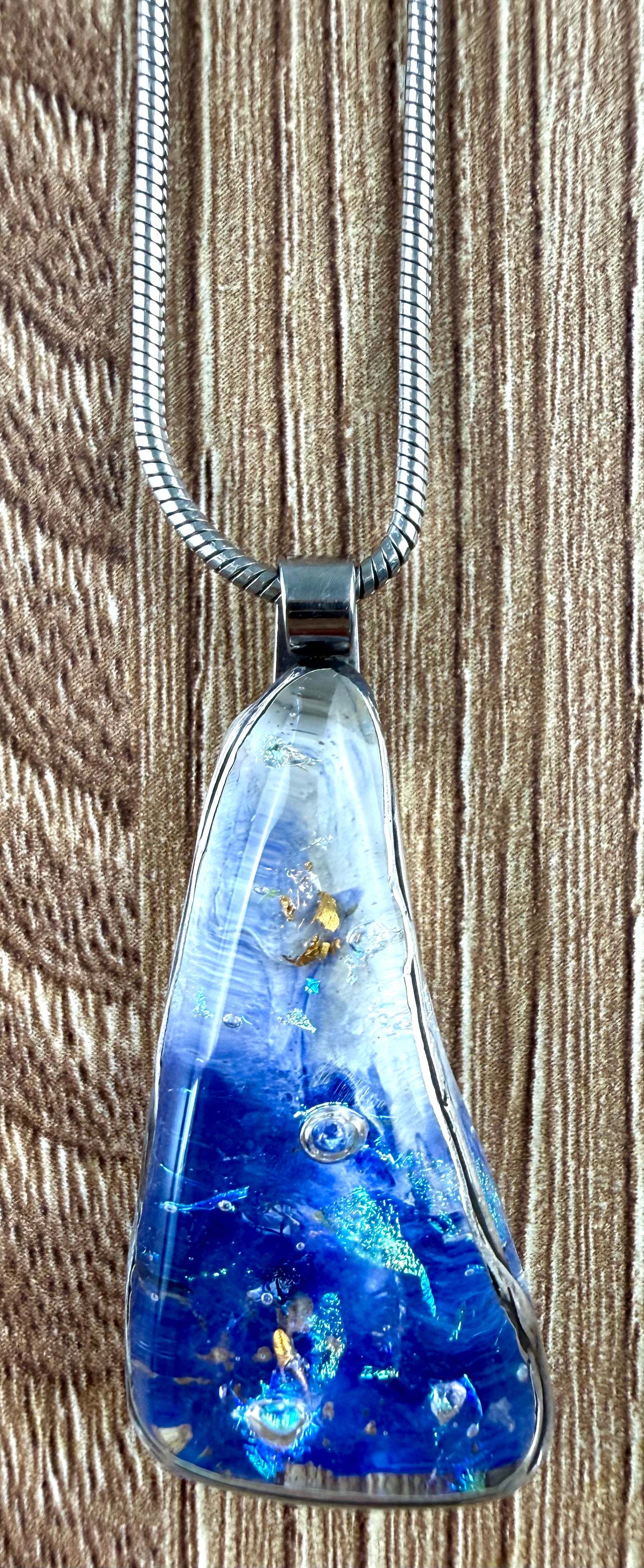 close up of pendant on Locally handcrafted cobalt blue resin or dichroic art glass pendant necklace on silver snake chain at Blue Sparrow Shop 