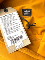 close up of sustainable tag on NWT PrAna Chakara 7/8 Leggings Deep Solstice showing $78 new price 
