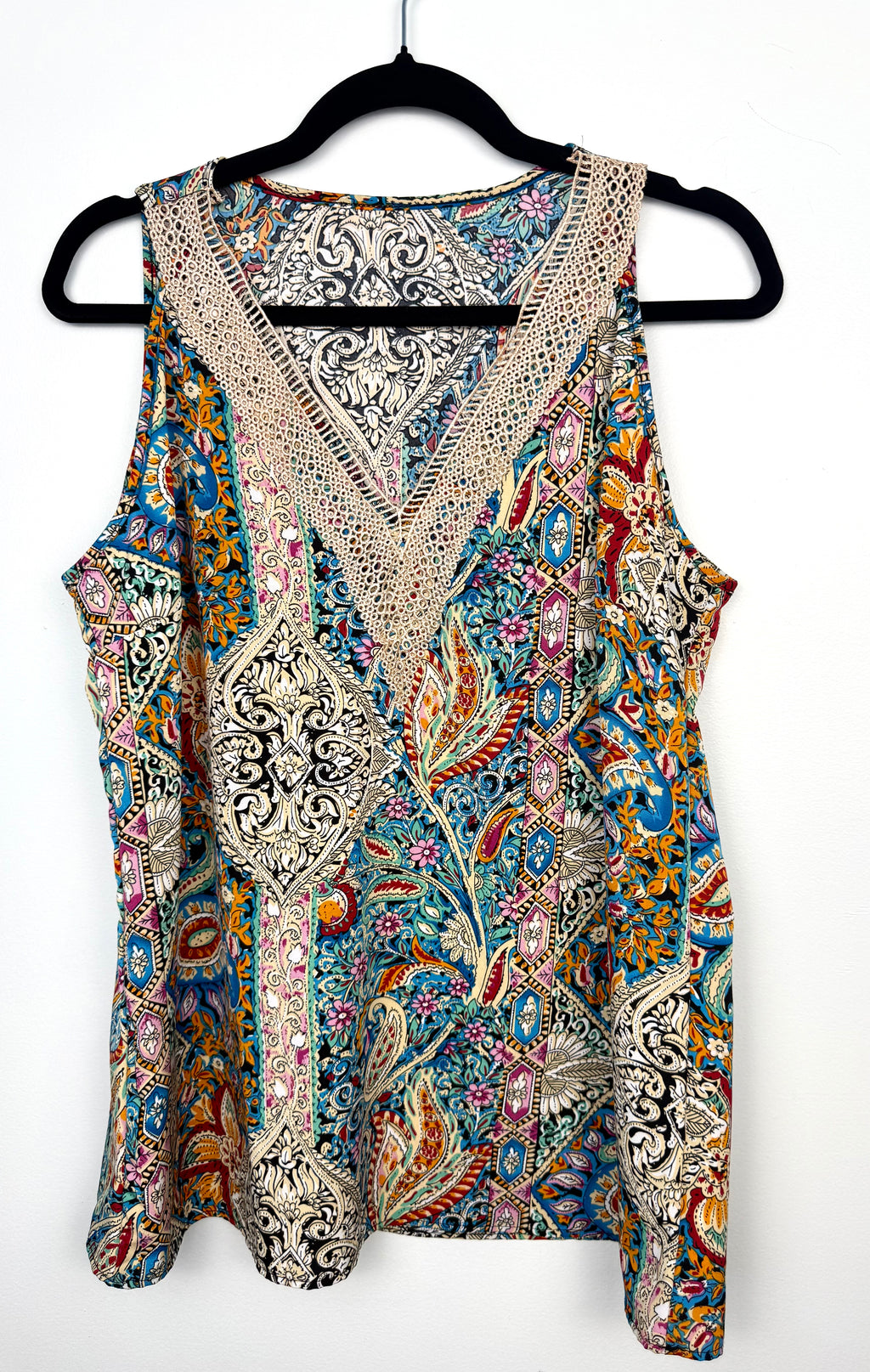 colourful paisley bohemian blouse with crochet lace neckline on hanger