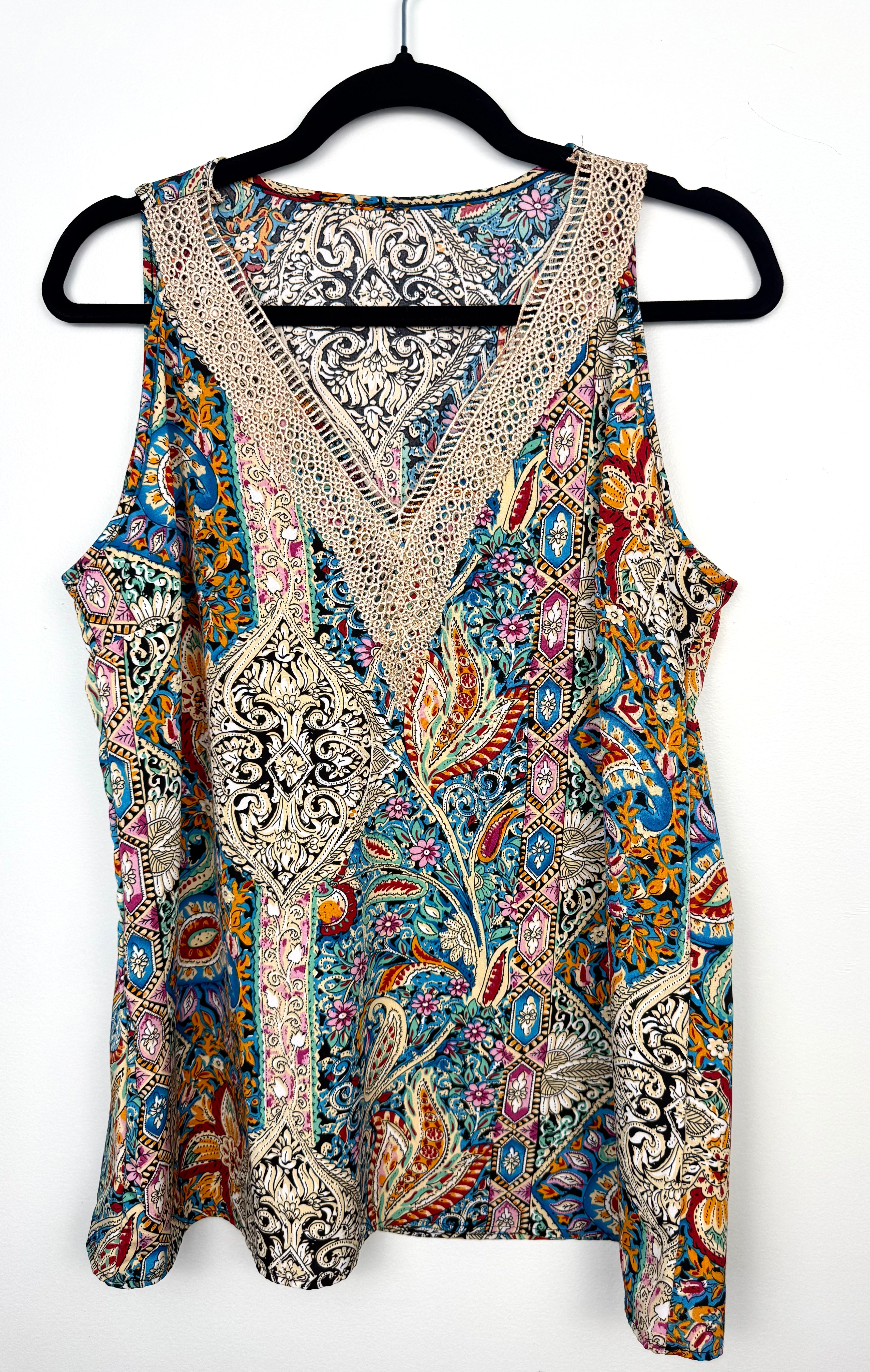 colourful paisley bohemian blouse with crochet lace neckline on hanger