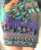 cuff crystal detail on Luxury Camilla Franks resort wear leggings featuring a vibrant animal print design with crystal embellished ankle detailing.