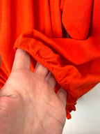 cuff detail on Melanie Lyne orange peasant blouse