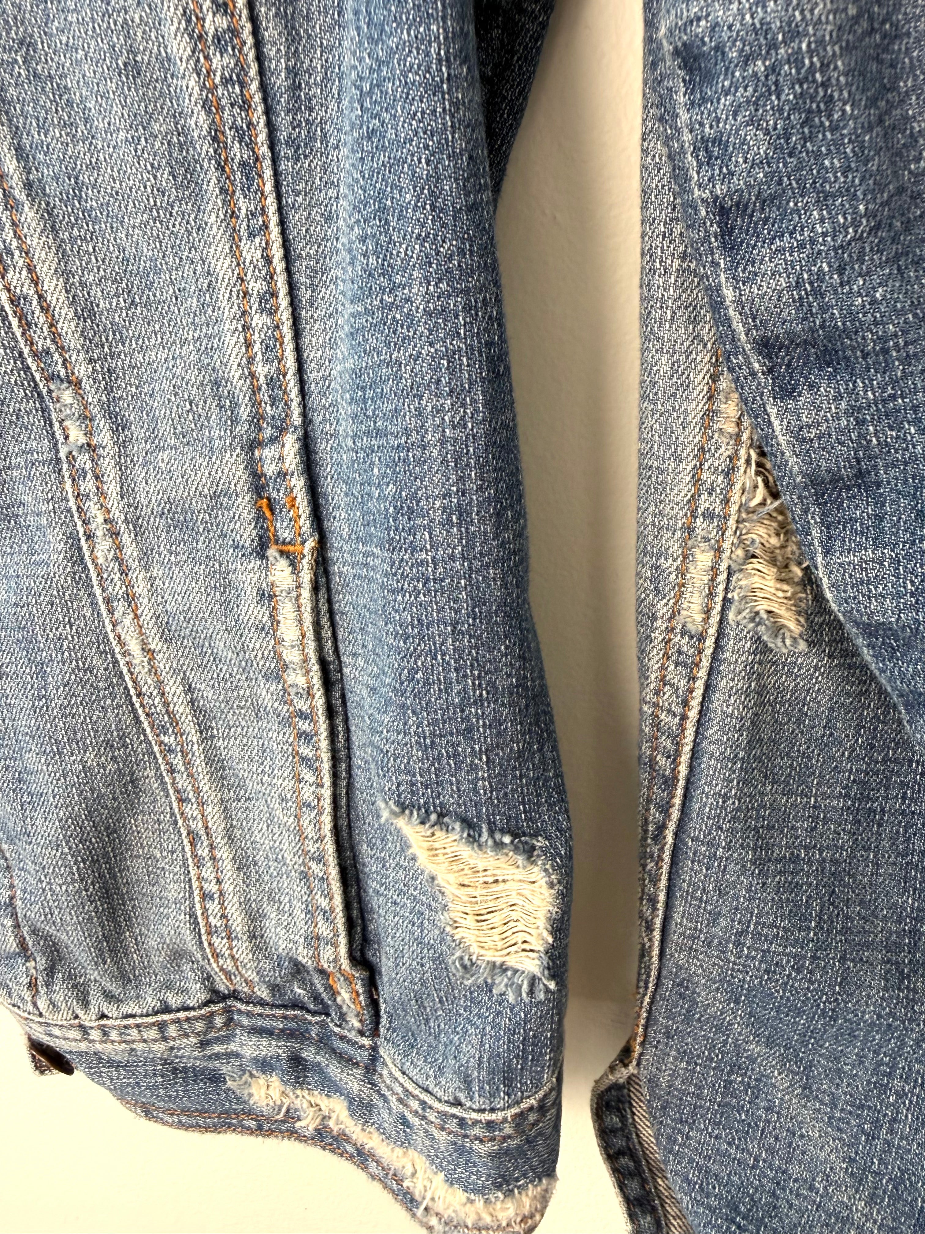 distressed hem and sleeve on Hollister HCO 100% Cotton Distressed Trucker Denim Jacket — Medium Wash | Size L at Blue Sparrow Shop