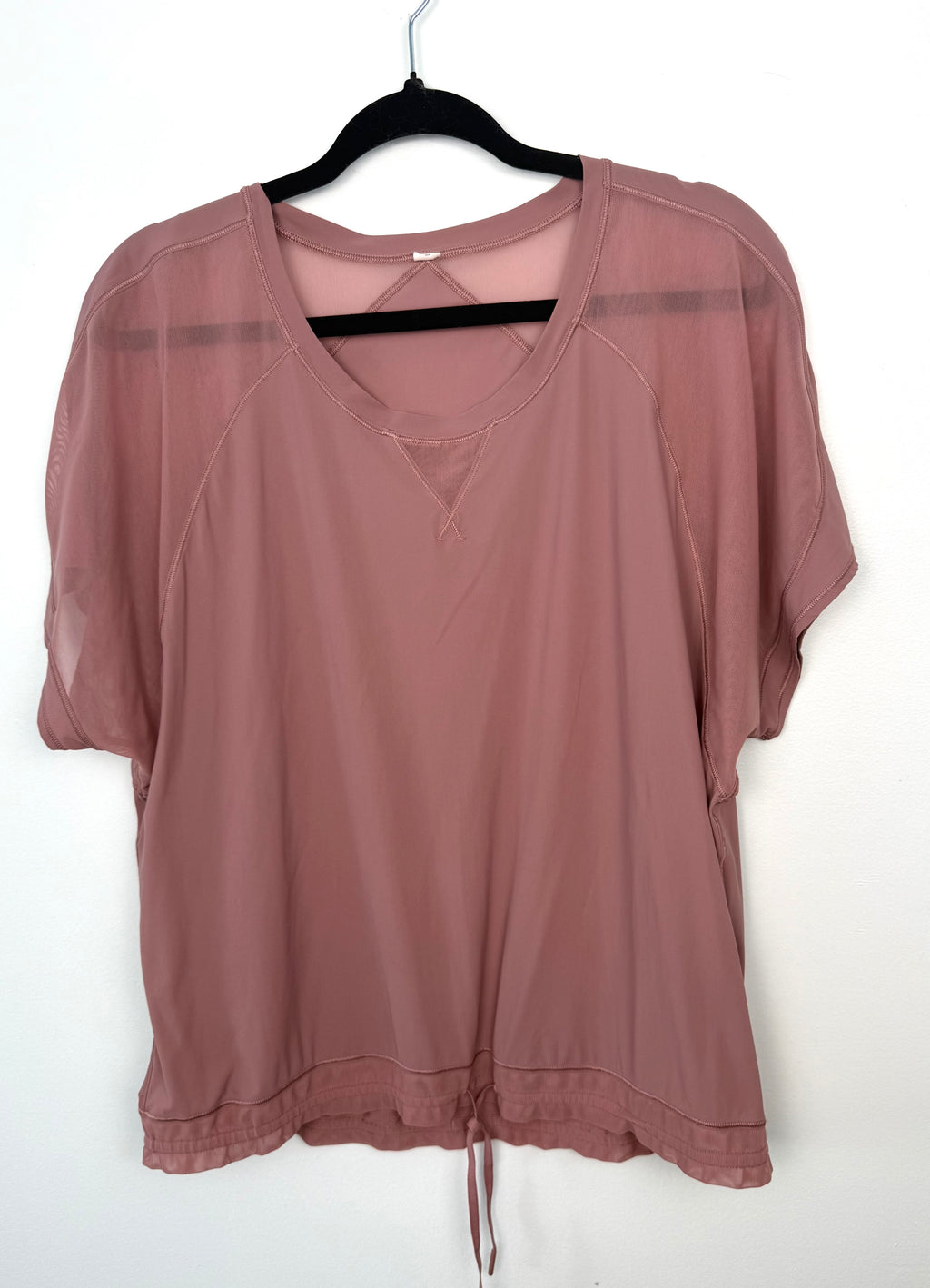 dusty rose Lululemon relaxed fit athletic top with mesh shoulder panels.
