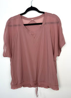 dusty rose Lululemon relaxed fit athletic top with mesh shoulder panels.
