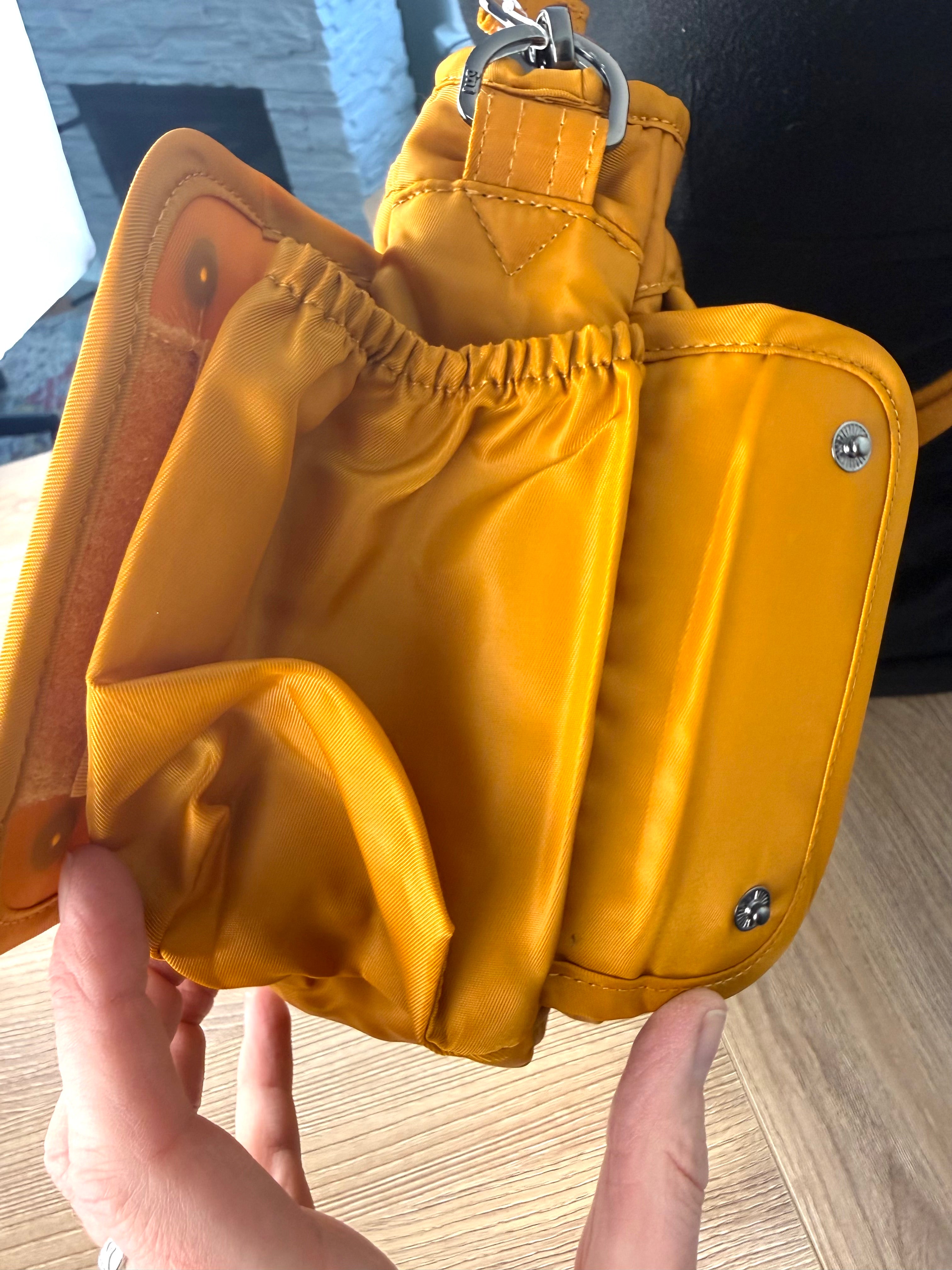 expanded water bottle holder on the side of  front of Lug Wings Travel Cross Body Bag 