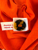 extra button on Melanie Lyne orange peasant blouse