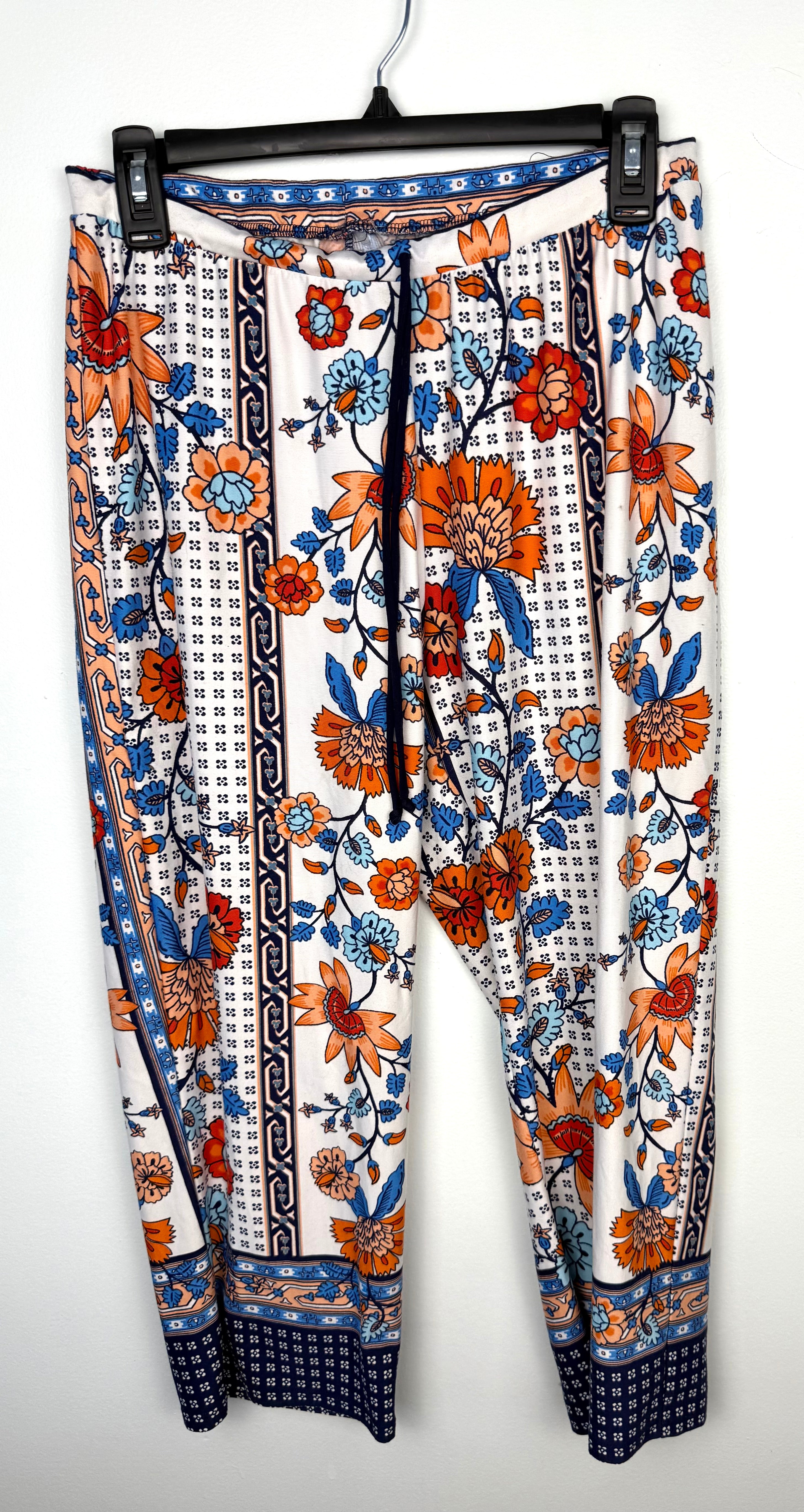 front of Casual boho patterned wide leg pants in orange and blue on hanger