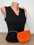 front of Handmade Madagascar 100% raffia orange crossbody bag leather flap   at Blue Sparrow Shop
