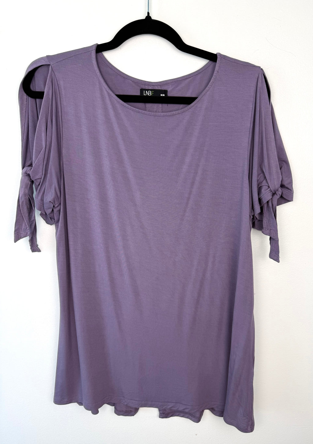 front of Leave Nothing But Footprints Bamboo Tee on hanger