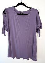 front of Leave Nothing But Footprints Bamboo Tee on hanger