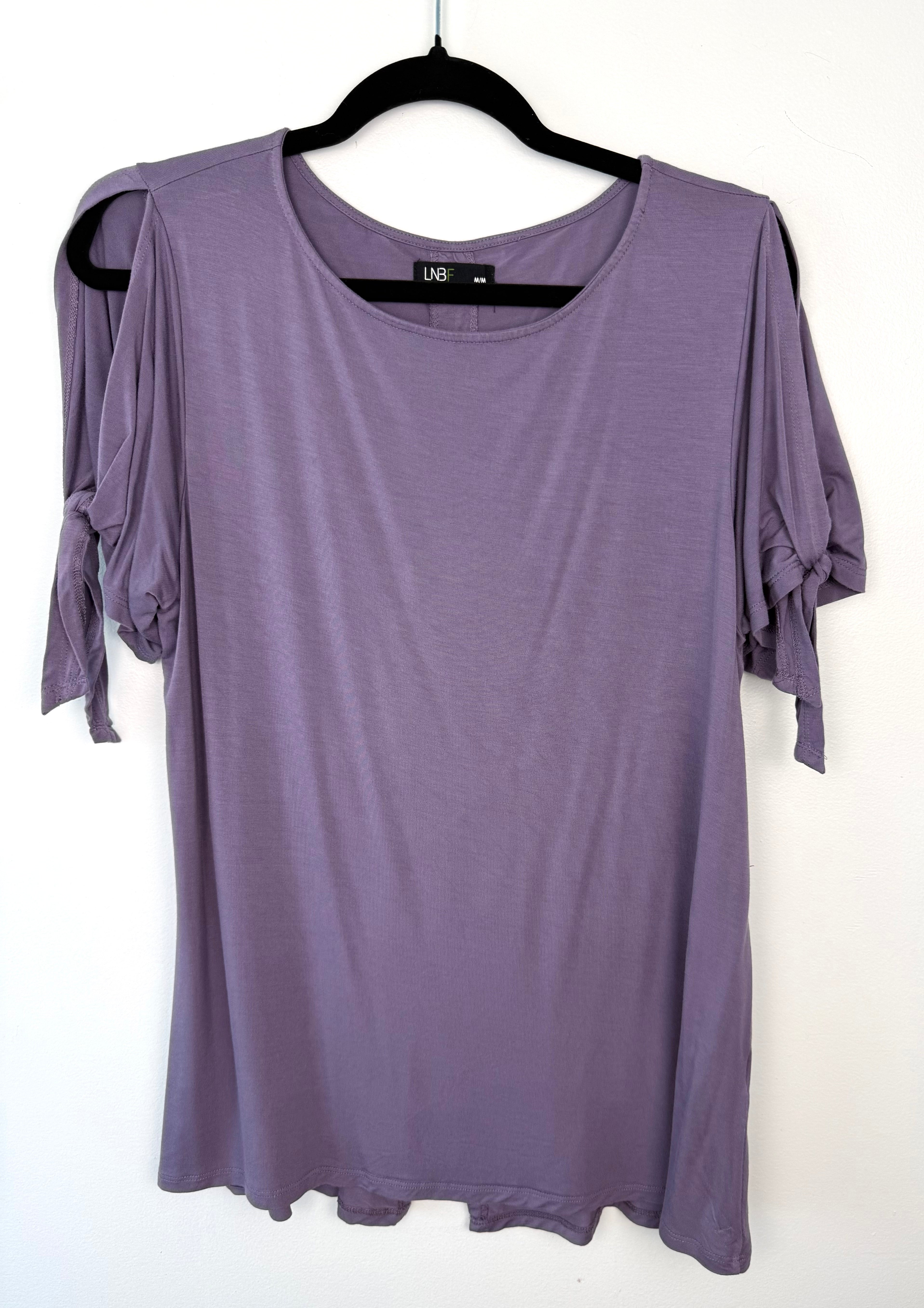 front of Leave Nothing But Footprints Bamboo Tee on hanger