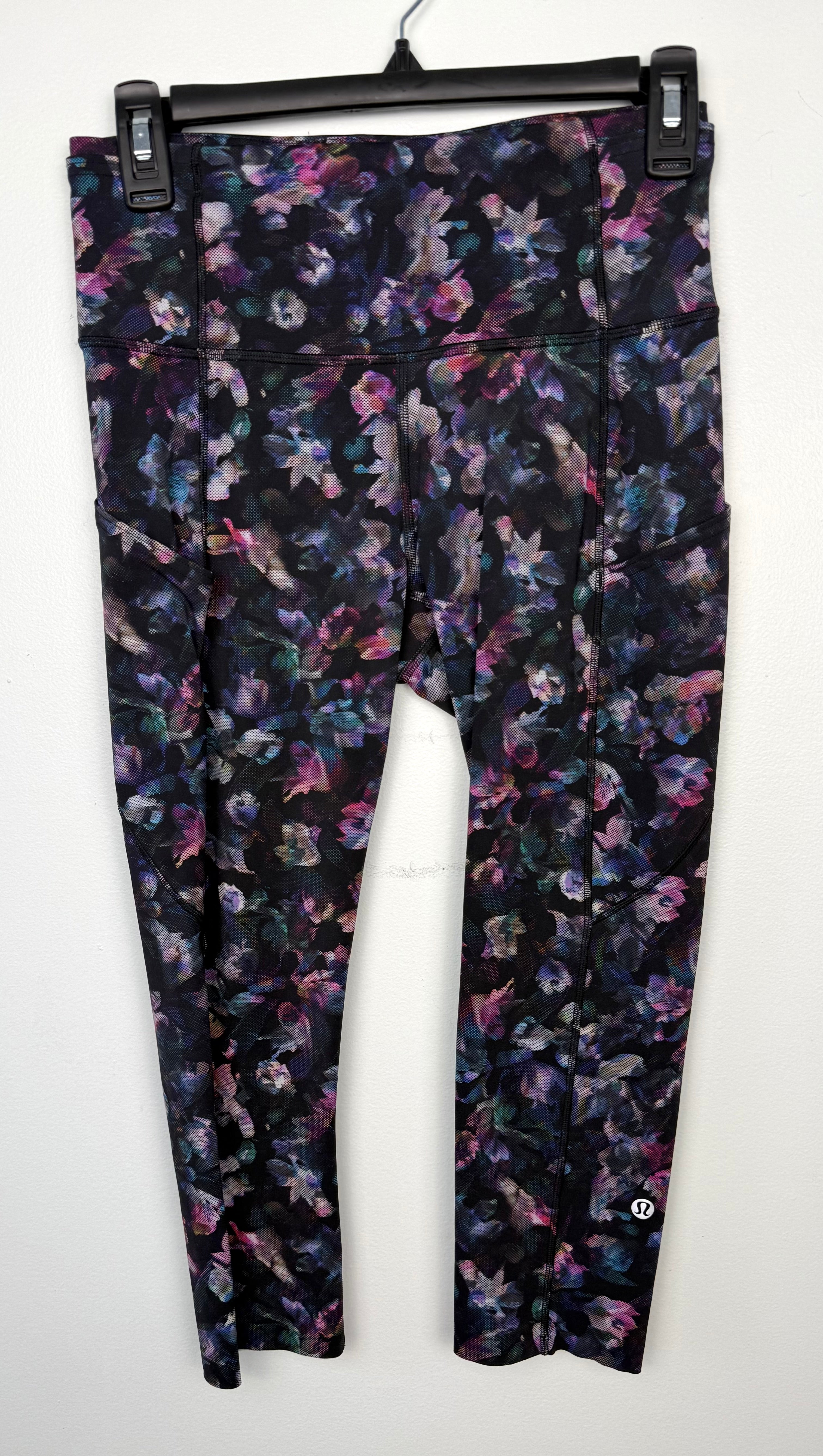 front of Lululemon floral capris | Size 6 at Blue Sparrow Shop  on hanger