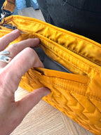 front phone pocket on Retired Lug Wings Travel Cross Body Bag in mustard yellow.