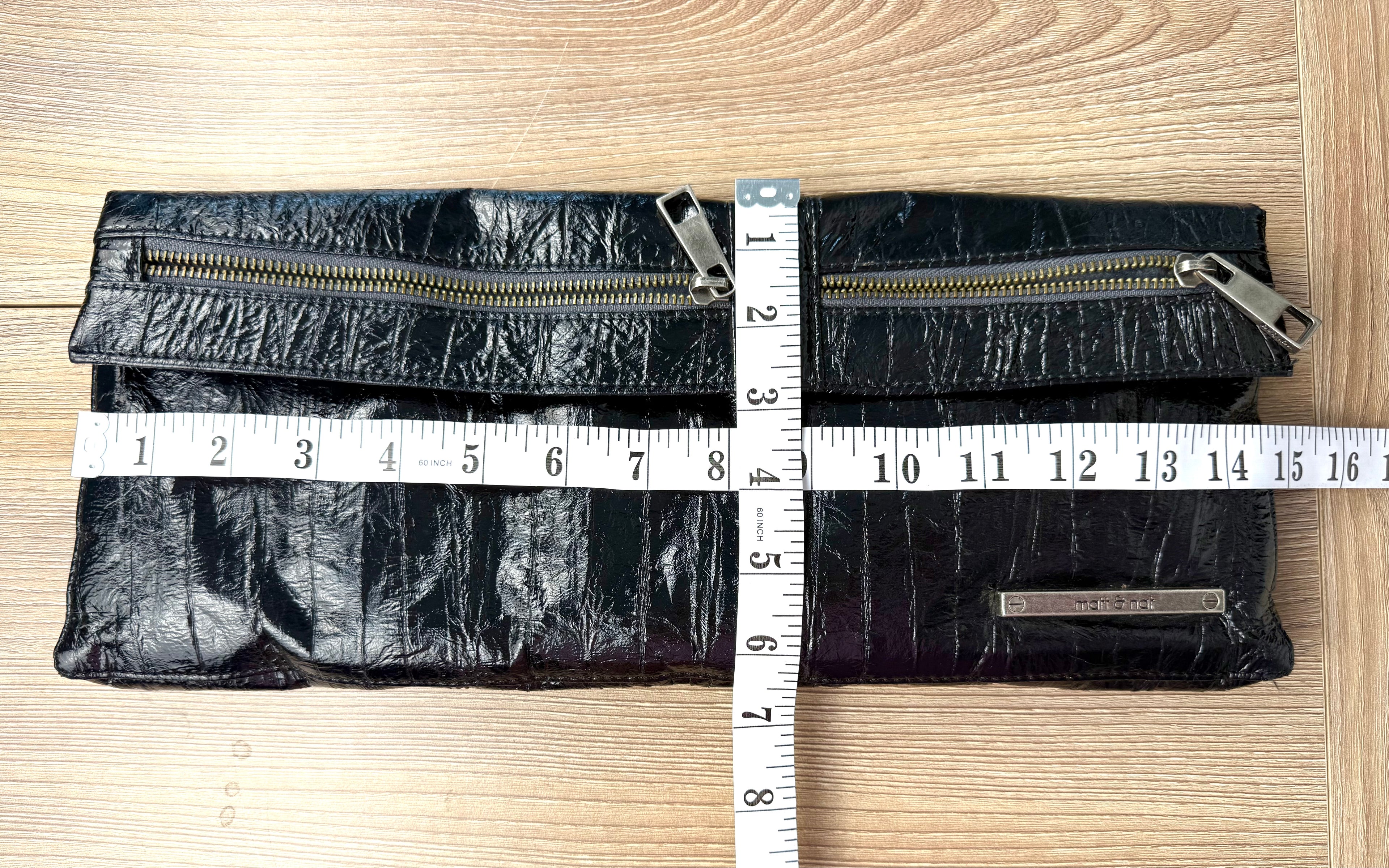 functioning back pockets on Matt & Nat Black Vegan Leather Clutch Bag measuring 14" wide and 6.5" high 