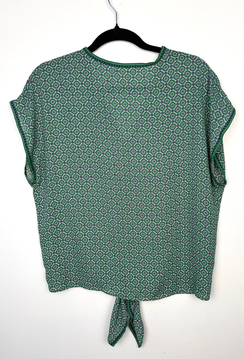 green patterned short sleeve blouse back view lightweight women’s summer top back view on hanger