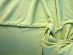 hand stitching on inside of Handmade lime green draped cardigan with asymmetrical colourblock striped panel in pink and green tones