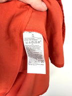 hang tag inside  of Banana Republic peplum top in rust 