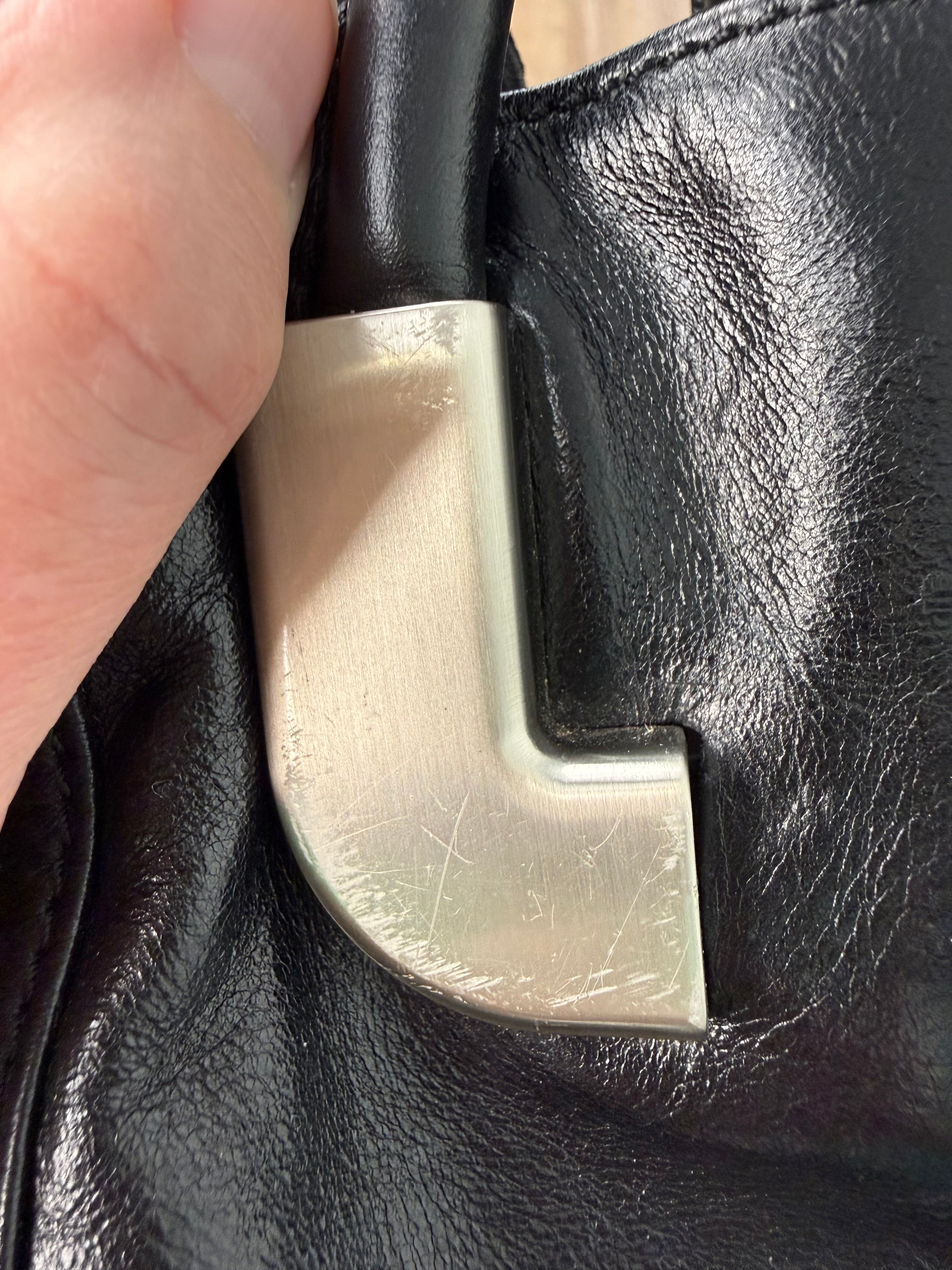 hardware with scratches on Dissona genuine leather black hobo shoulder bag at Blue Sparrow Shop Resale Canada 