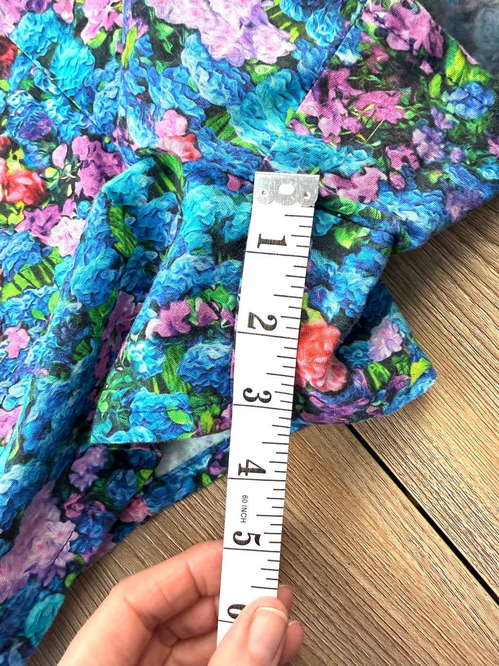 inseam on shorts part of Birds of North America floral romper with impressionist hydrangea print measuring 3" approx 