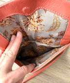 inside front pocket on Coral Coloured HOBO International Leather Crossbody Wristlet Bag 