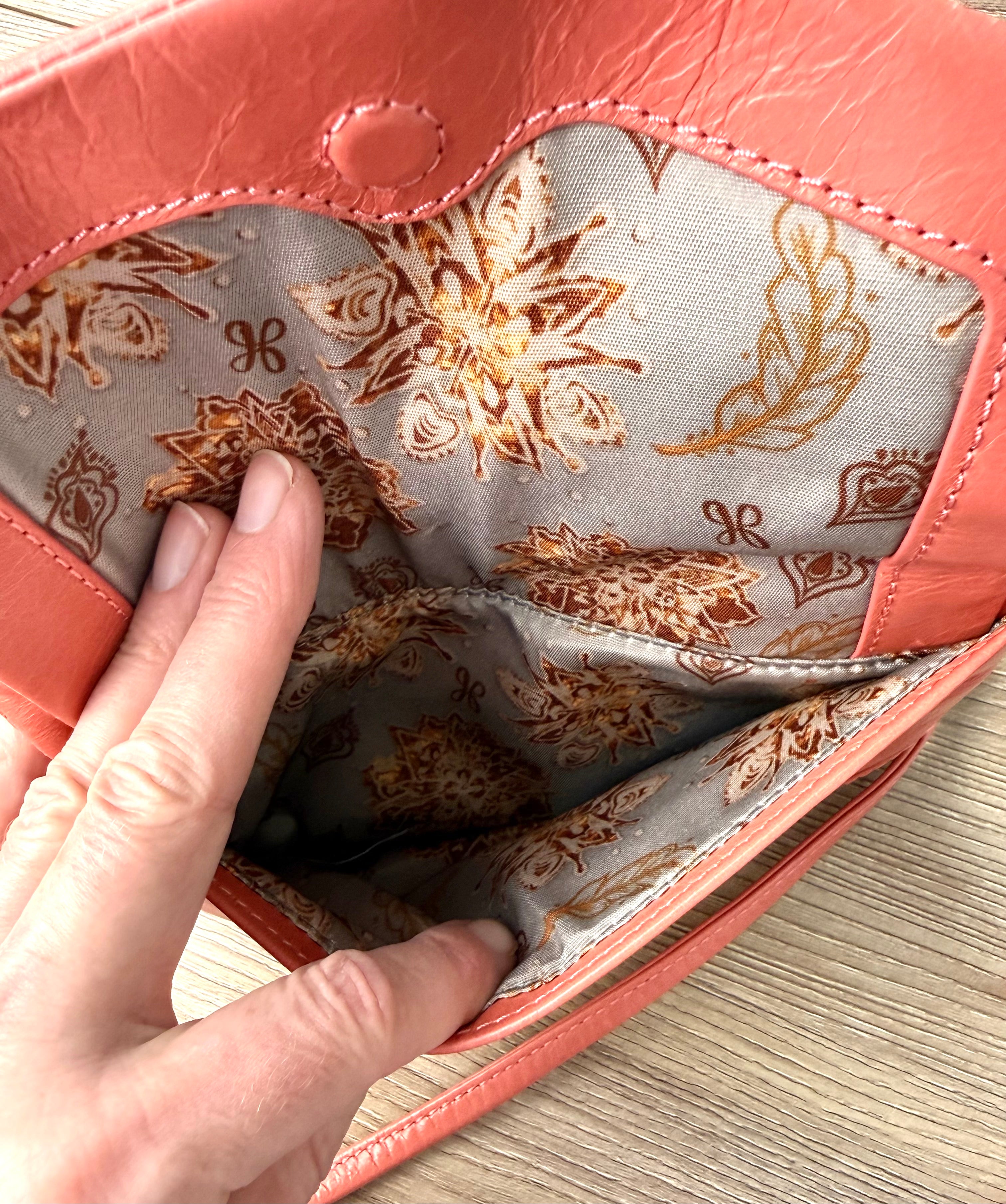 inside front pocket on Coral Coloured HOBO International Leather Crossbody Wristlet Bag 