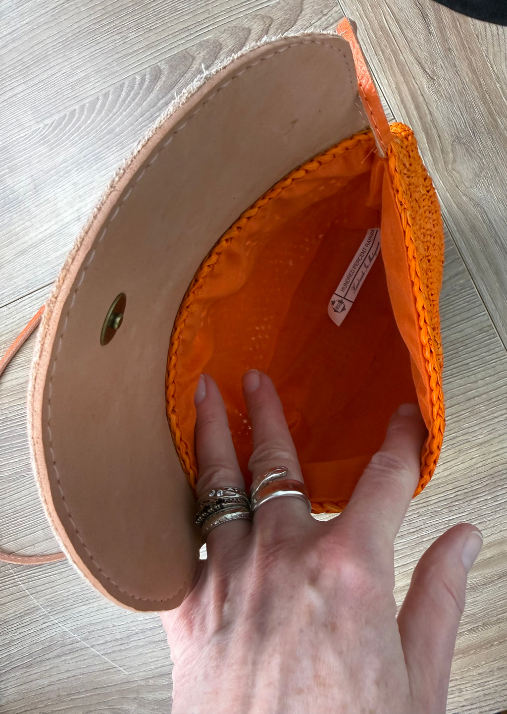 inside of Handmade Madagascar 100% raffia orange crossbody bag leather flap 
