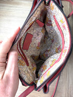 inside of Nanette Lepore Pink Pebbled Leather Crossbody Bag at Blue Sparrow Shop  showing floral lining