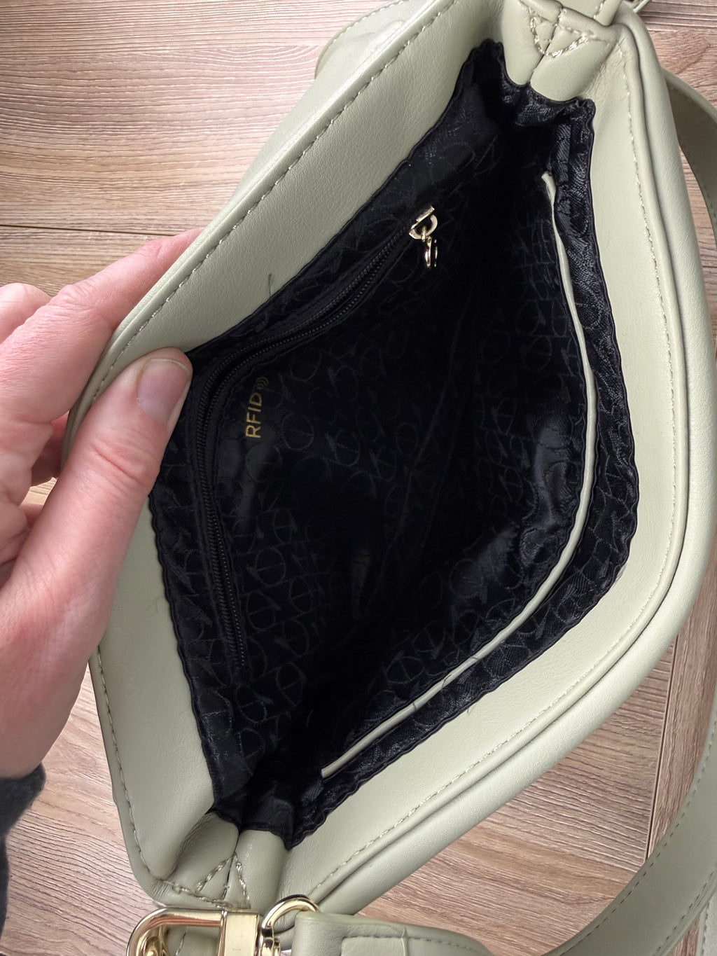 inside of  Riona Sage Green Crossbody Bag | RFID  protection travel purse 