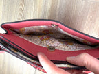 inside of front pocket on Nanette Lepore Pink Pebbled Leather Crossbody Bag at Blue Sparrow Shop 