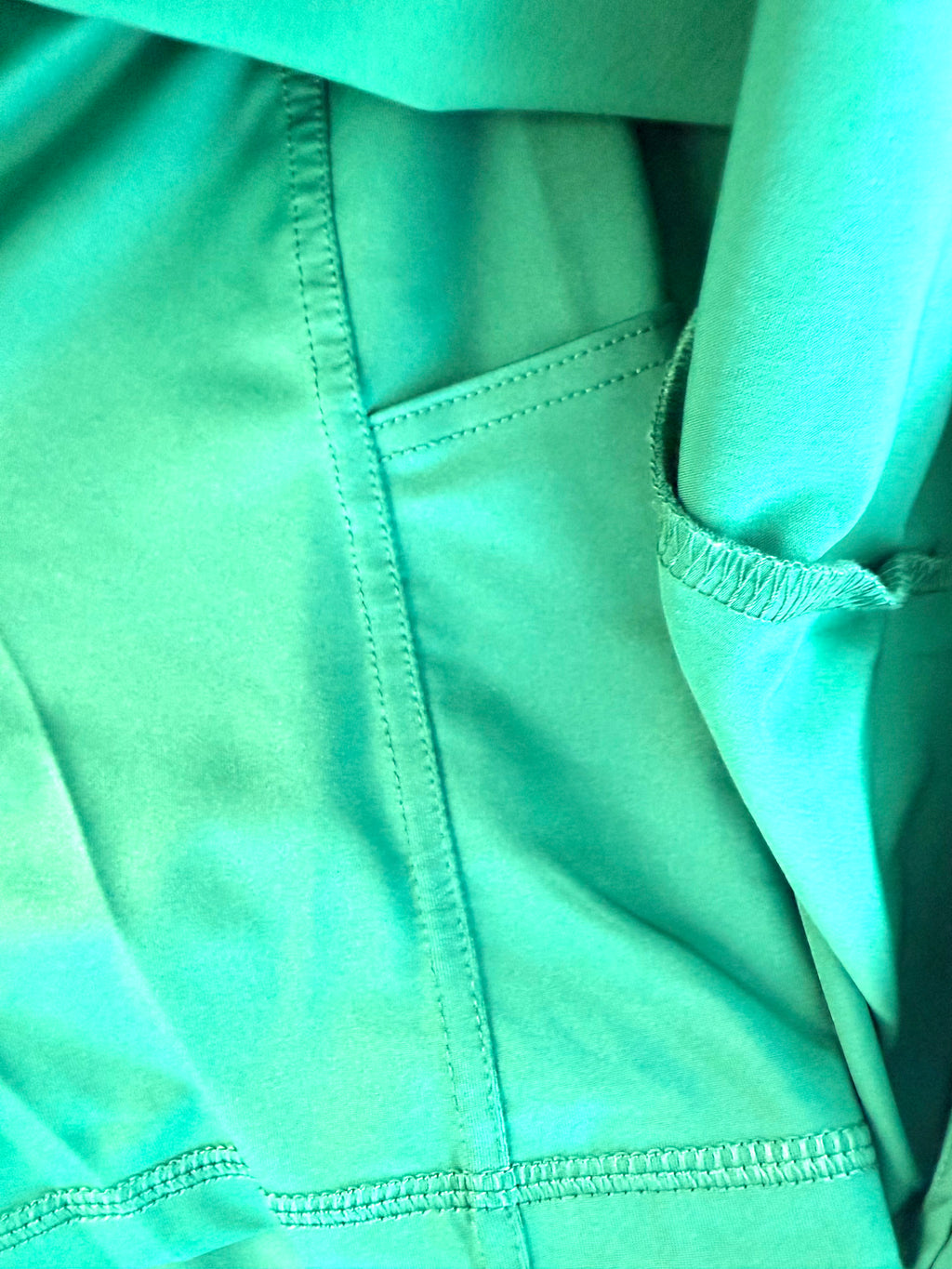 inside of lole green skort showing shorts underneath and pockets on inside shorts