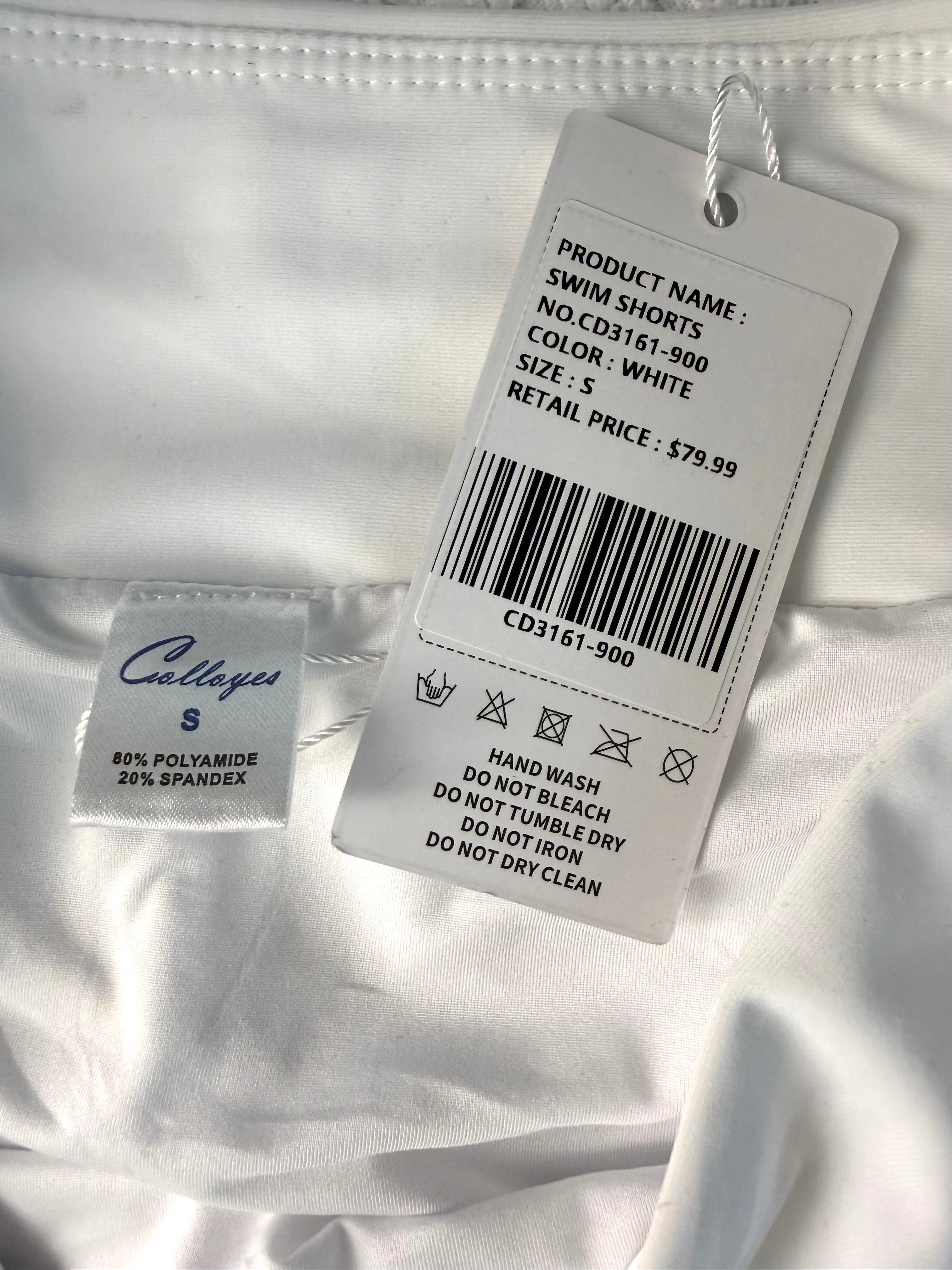 inside tag and original price tag on NWT white swim trunks size small compare at 79.99 at Blue Sparrow Resale Shop 