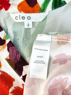 inside tag on Cleo tie-front V-neck floral blouse in bold painterly orange red and green botanical print