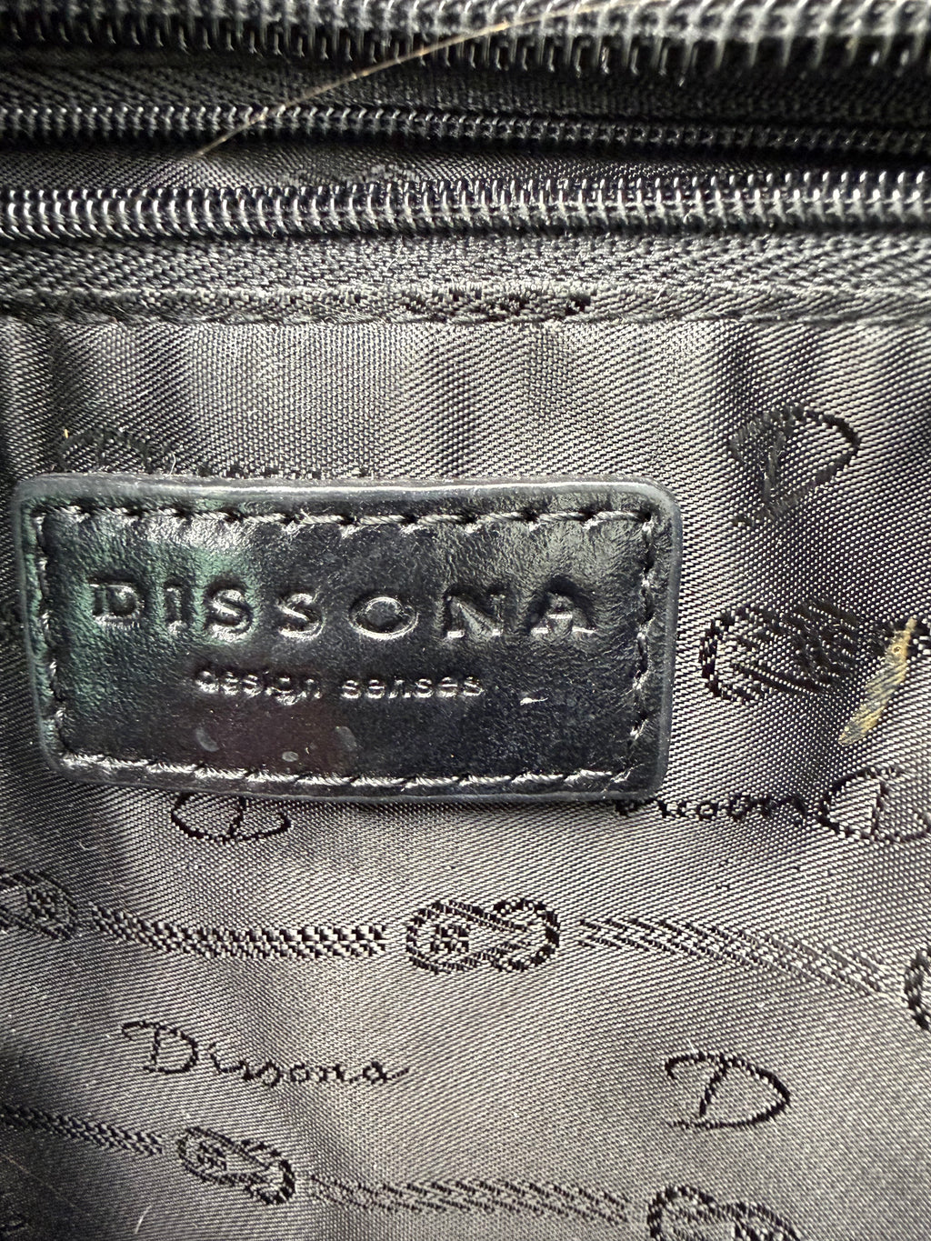 inside tag on Dissona genuine leather black hobo shoulder bag at Blue Sparrow Shop Resale Canada 