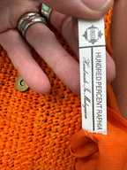inside tag on Handmade Madagascar 100% raffia orange crossbody bag leather flap 