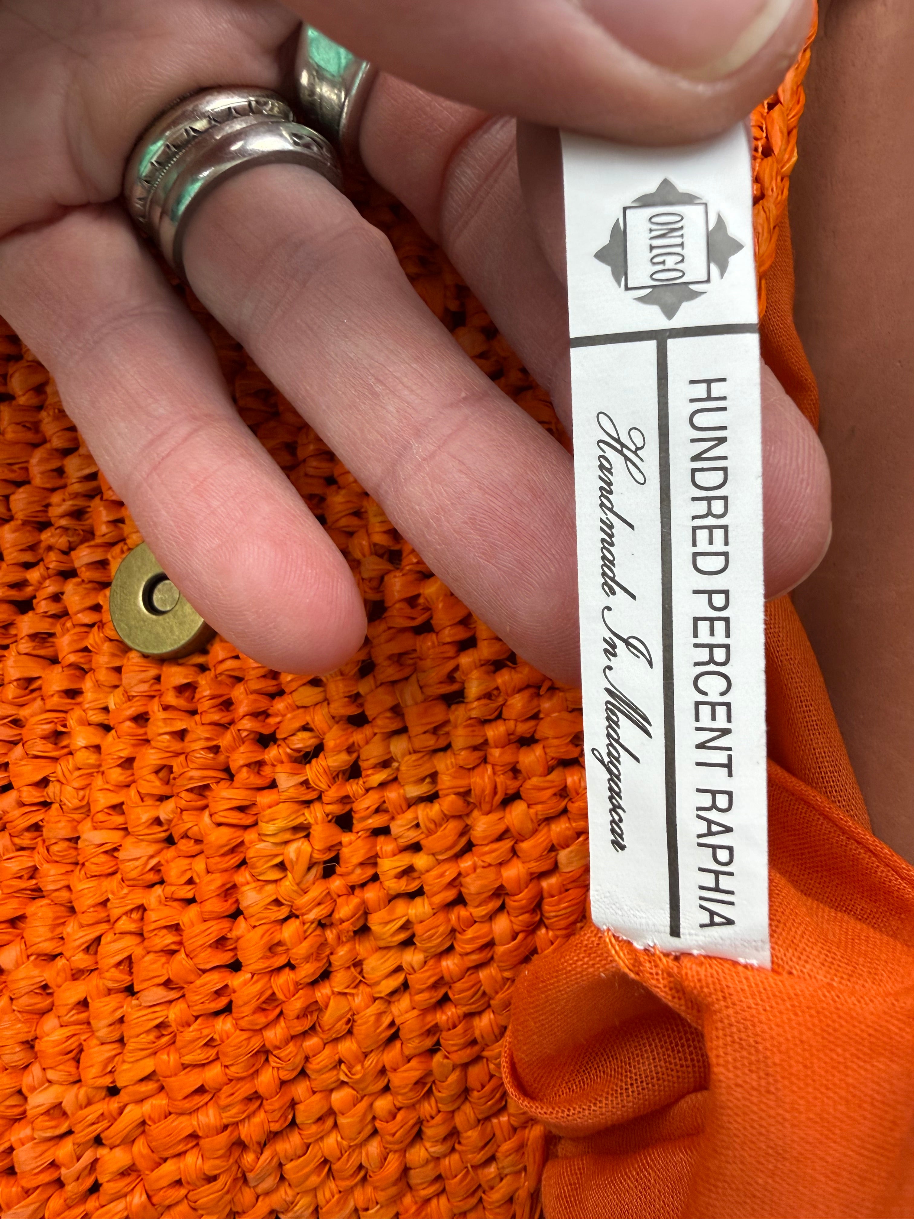inside tag on Handmade Madagascar 100% raffia orange crossbody bag leather flap 