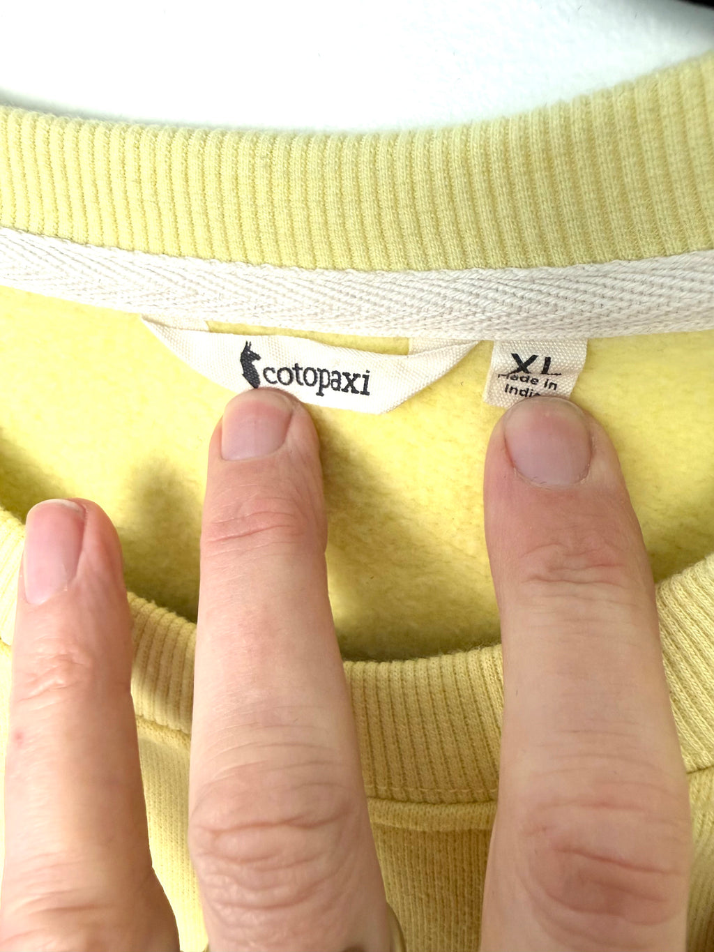 inside tag on preloved Cotopaxi Do Good sweatshirt