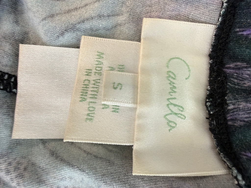 inside tag on Luxury Camilla Franks resort wear leggings featuring a vibrant animal print design with crystal embellished ankle detailing showing size small