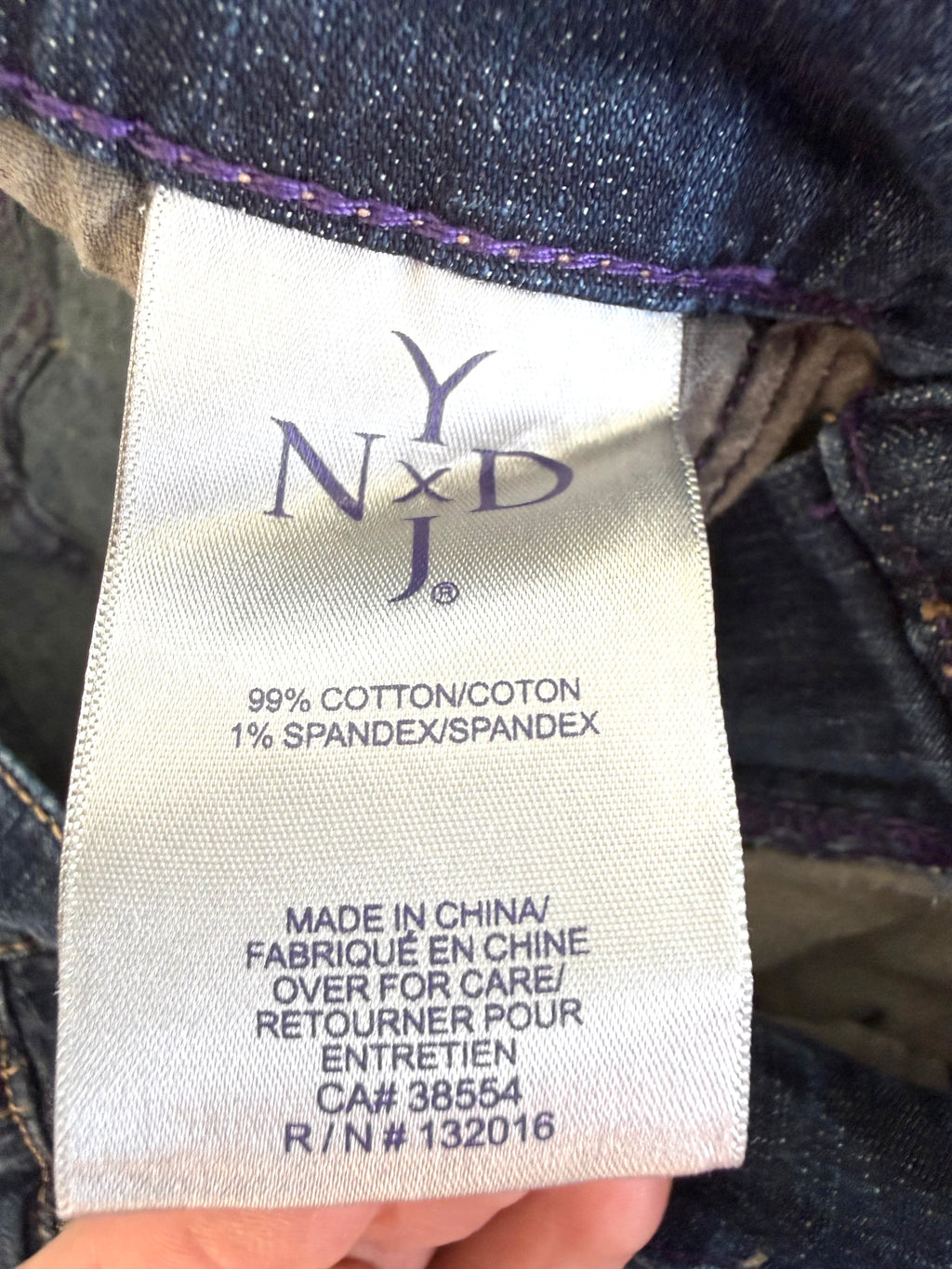inside tags on 99% Cotton NYDJ Dark Wash Petite Straight Leg Jeans | Size 10P at Blue Sparrow Shop 
