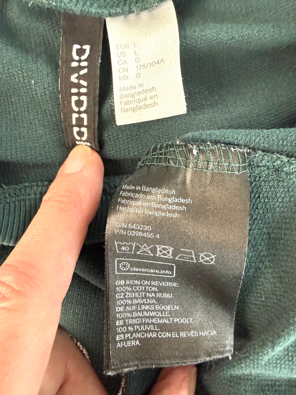 inside tags on H&M Divided teal green 100% cotton graphic crew neck sweatshirt with "Property of No One" distressed white lettering, front view on hanger — Blue Sparrow pre-loved women's fashion