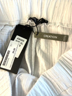 inside tags on NWT Creation 100% Cotton Gauze Wide-Leg Pants — White | Button Hem Detail | Size XL at Blue Sparrow Shop